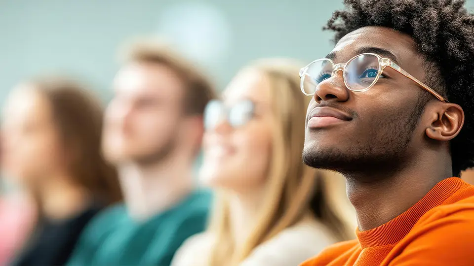 College students attentively listening to a lecture in a classroom